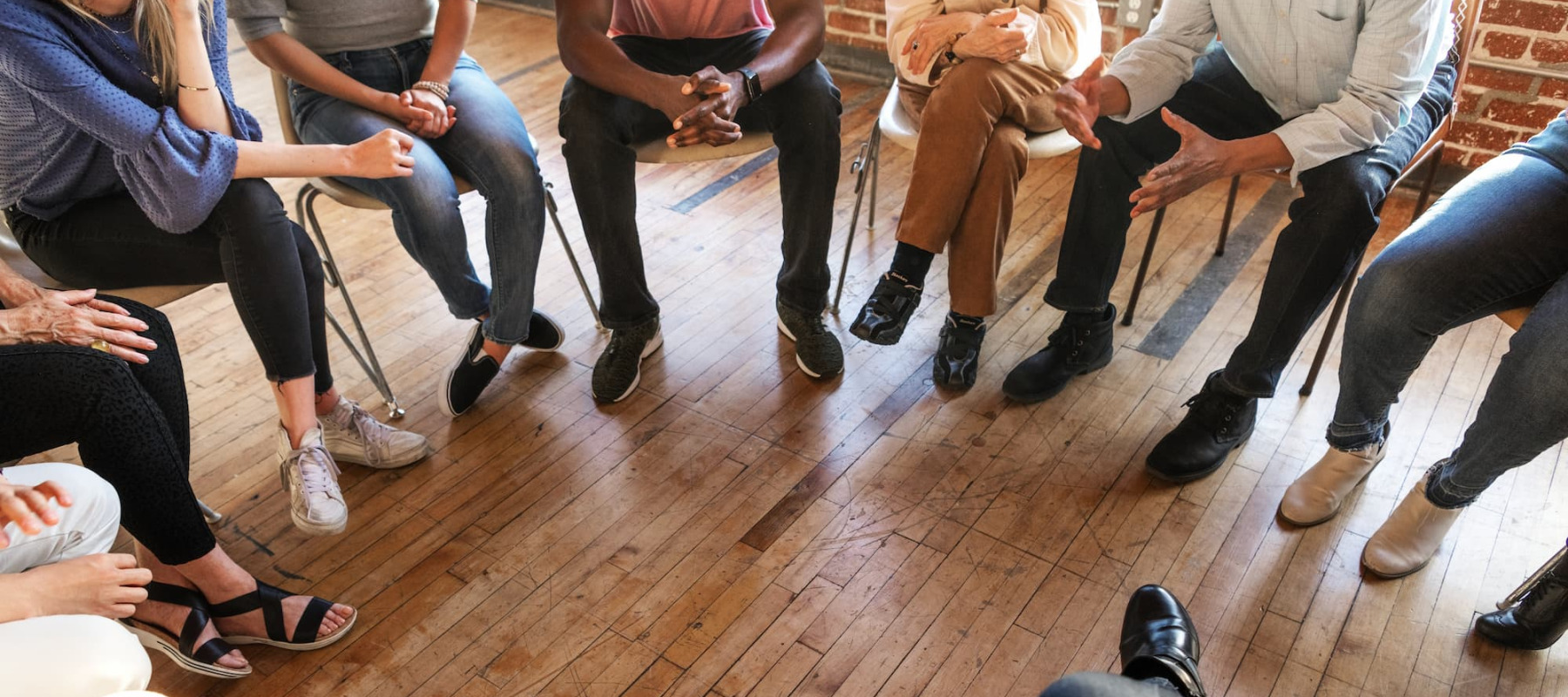 A photo of a diverse group of people sitting in a circle