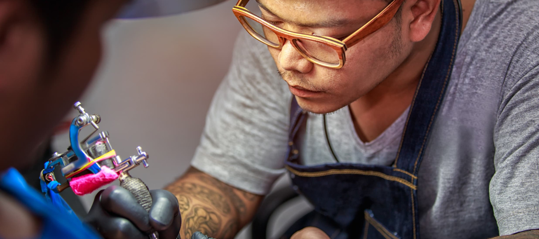 A photo of a man getting a tattoo