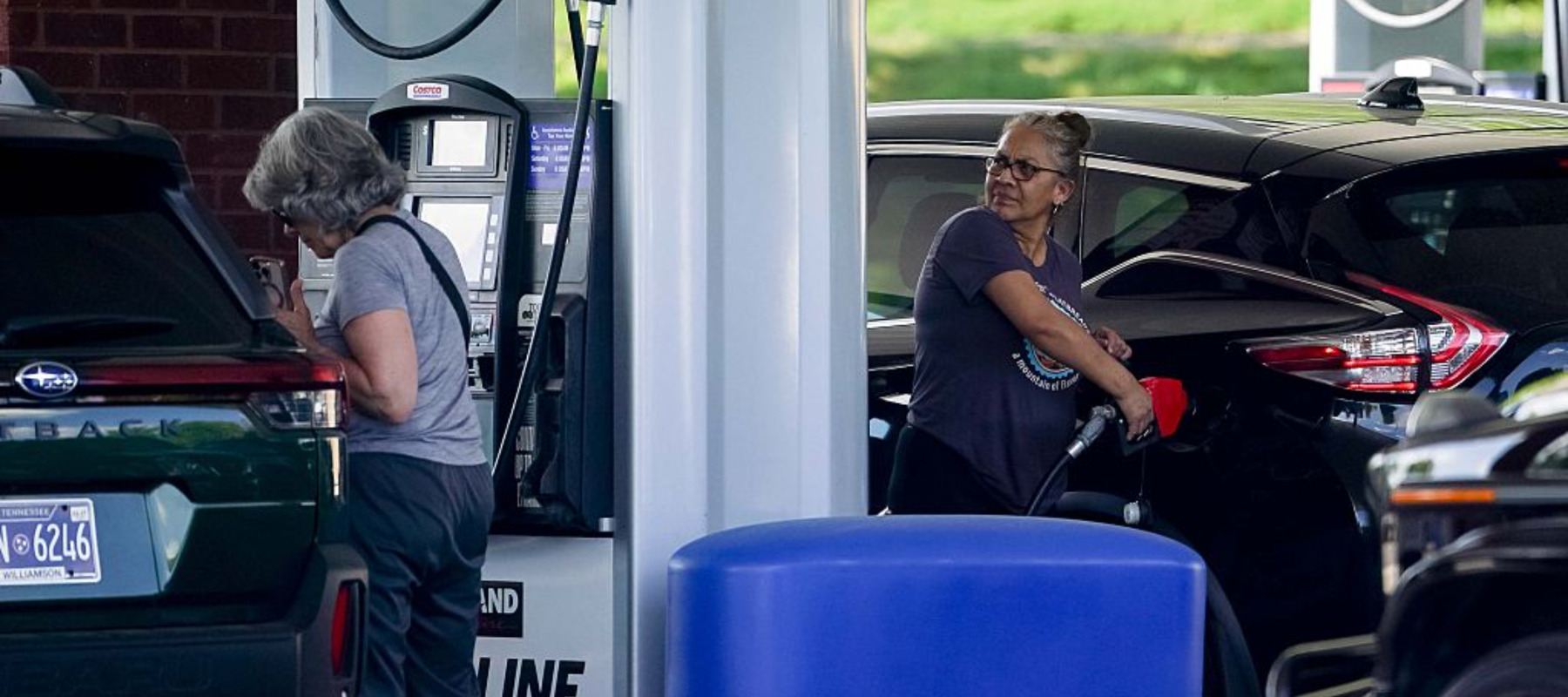 Woman filling up her tank at a Costco gas station