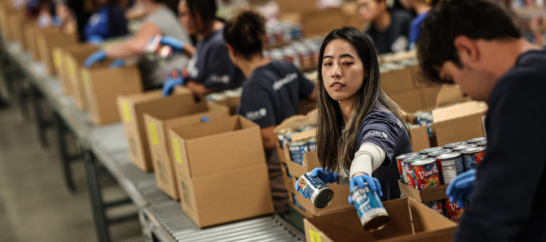 Volunteer Jennifer Le packs canned goods at the L.A. Regional Food Bank.