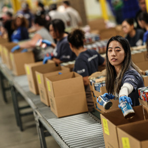 Volunteer Jennifer Le packs canned goods at the L.A. Regional Food Bank.