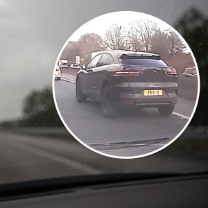 Image of a dreary road with bubble overlay of Jaguar seen from behind.