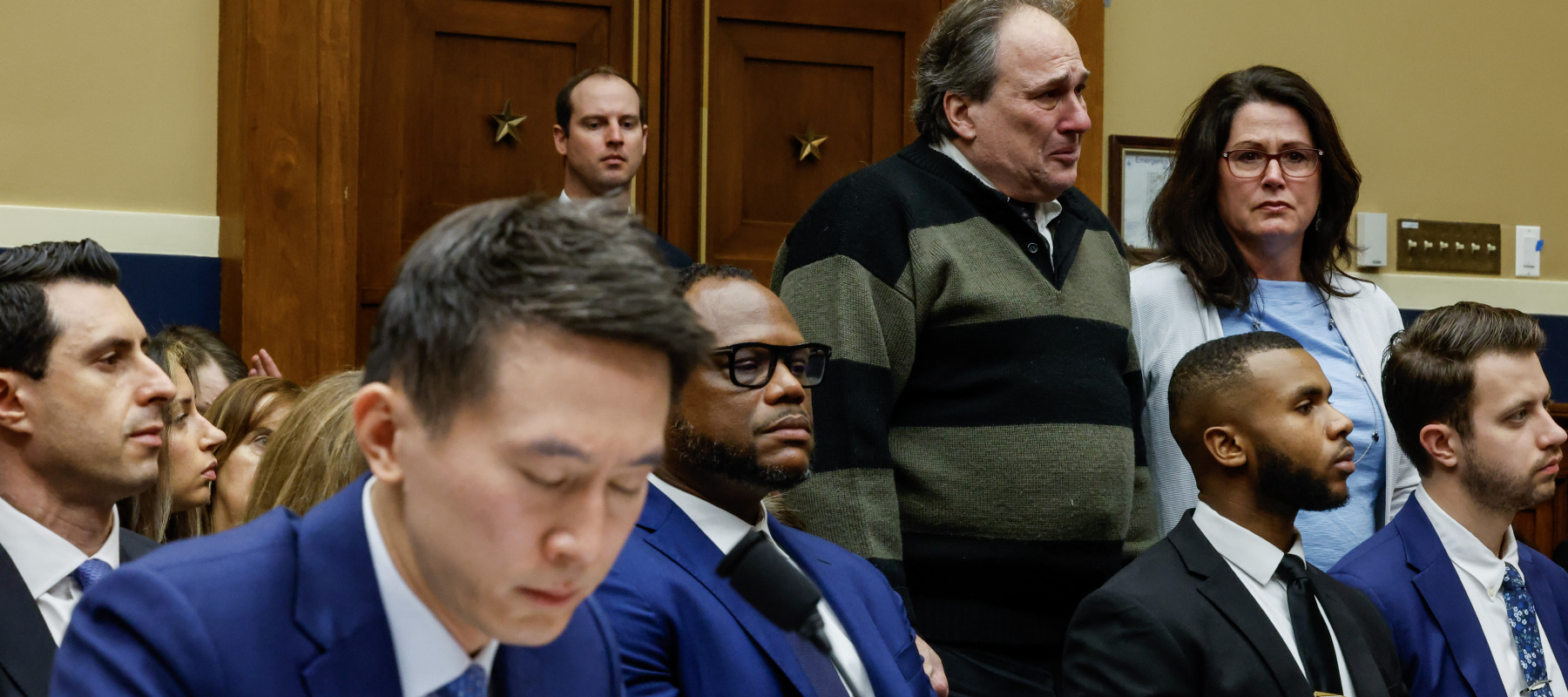 Dean and Michelle Nasca, who filled a lawsuit against TikTok for the death of their son Chase, stand as TikTok CEO Shou Zi Chew testifies before a House committee in 2023.