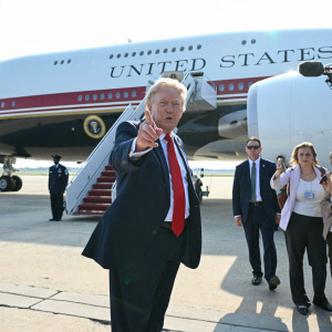 Trump gestures toward the media while standing in front of Air Force One.