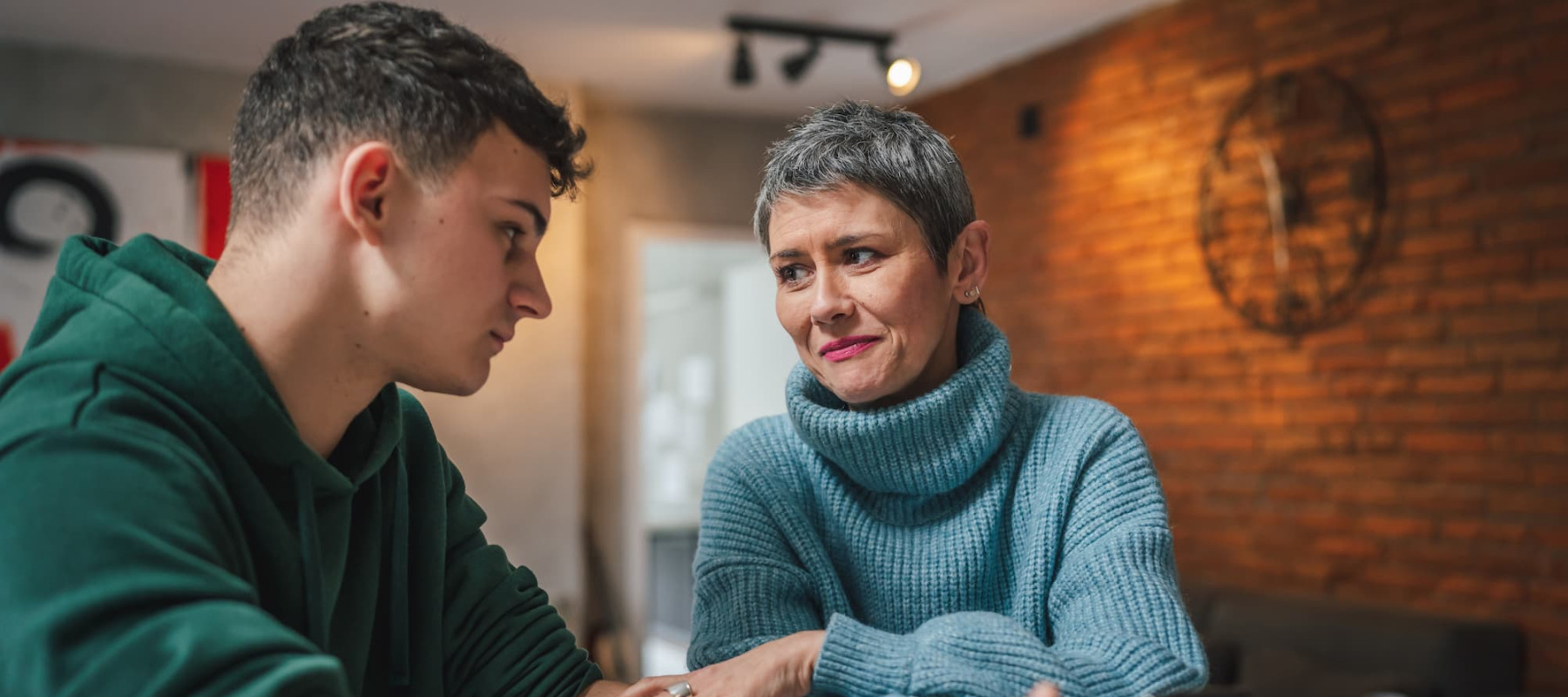 A photo of a mother talking to her adult son