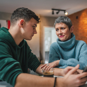 A photo of a mother talking to her adult son
