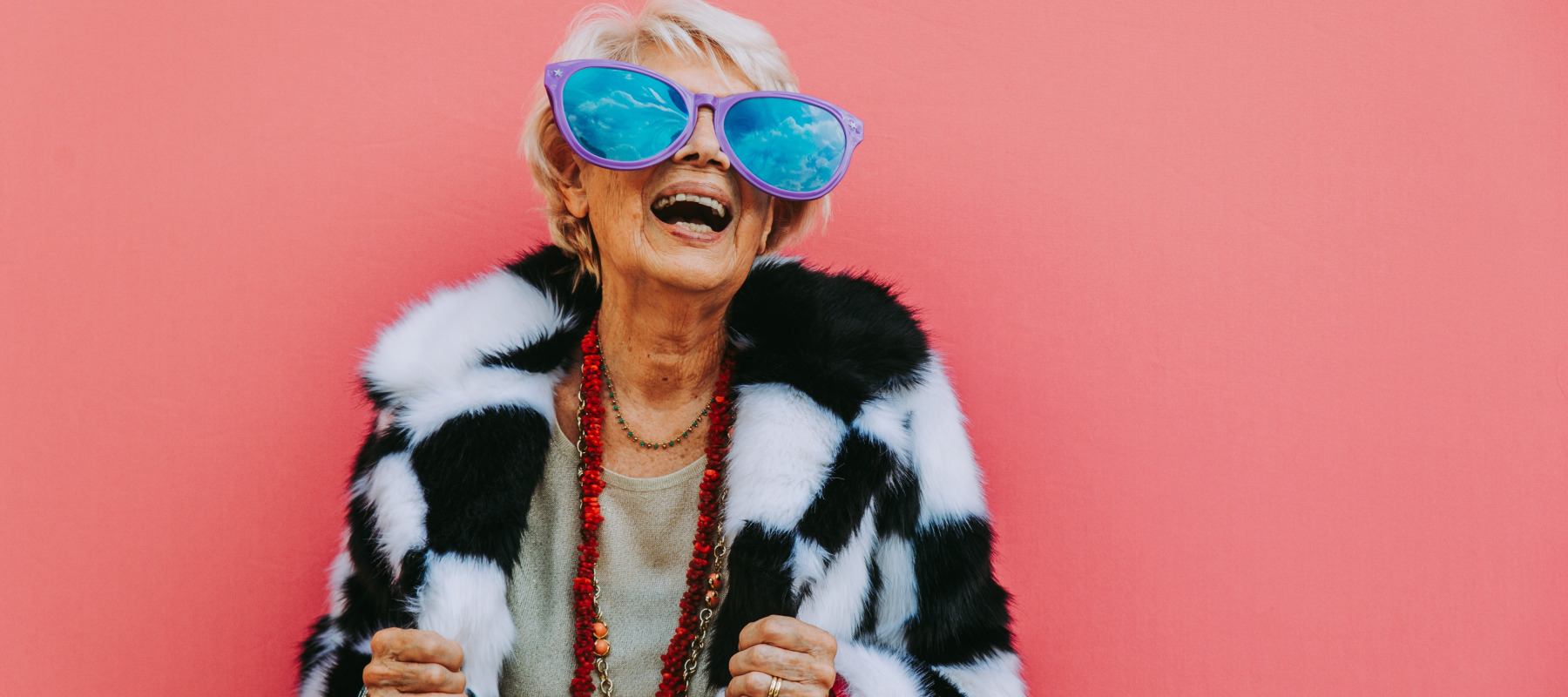 Happy grandmother posing on colored backgrounds.