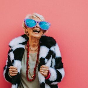 Happy grandmother posing on colored backgrounds.
