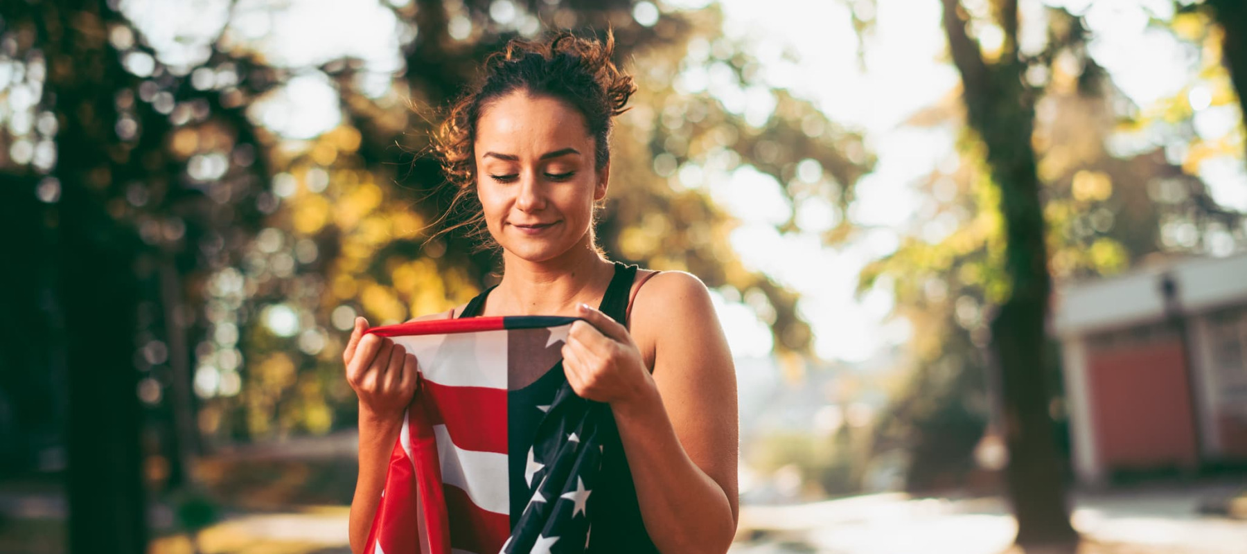 A photo of a millennial looking at an American flag