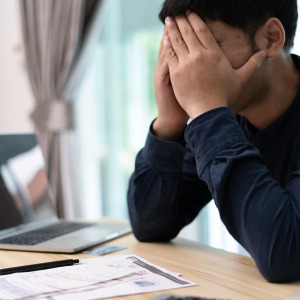 A photo of a man stressed about money