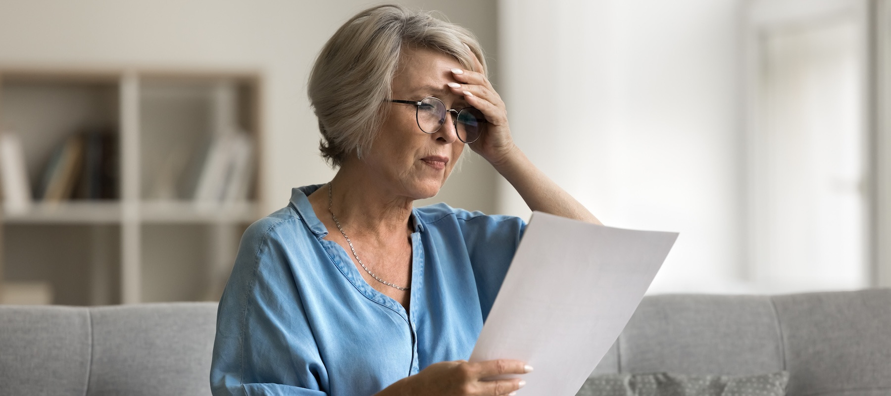 Concerned retiree looking at her finances.