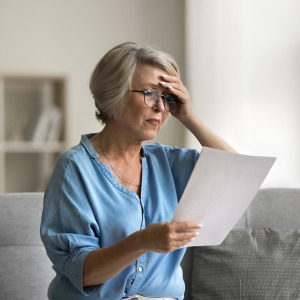 Concerned retiree looking at her finances.