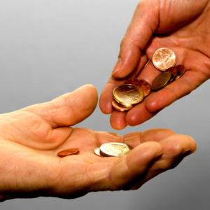 Photo of hands exchanging coins