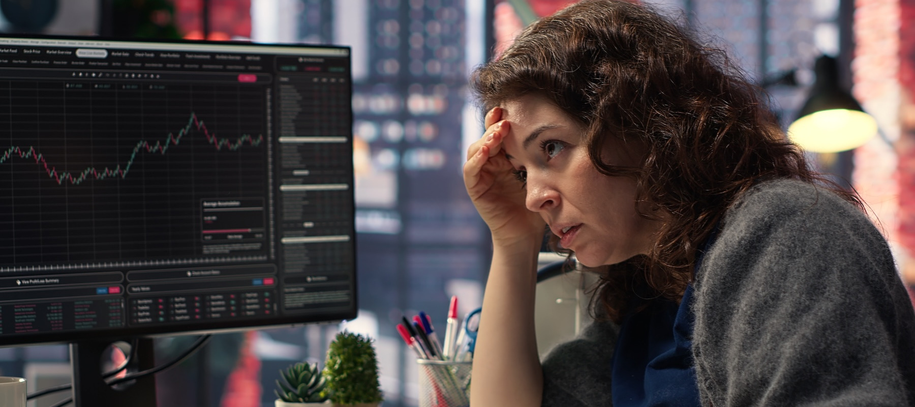 Stressed woman looking at her investments.