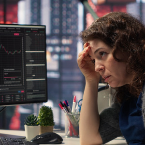 Stressed woman looking at her investments.