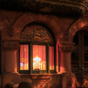 Photo of a Brooklyn brownstone with a bright light shining inside