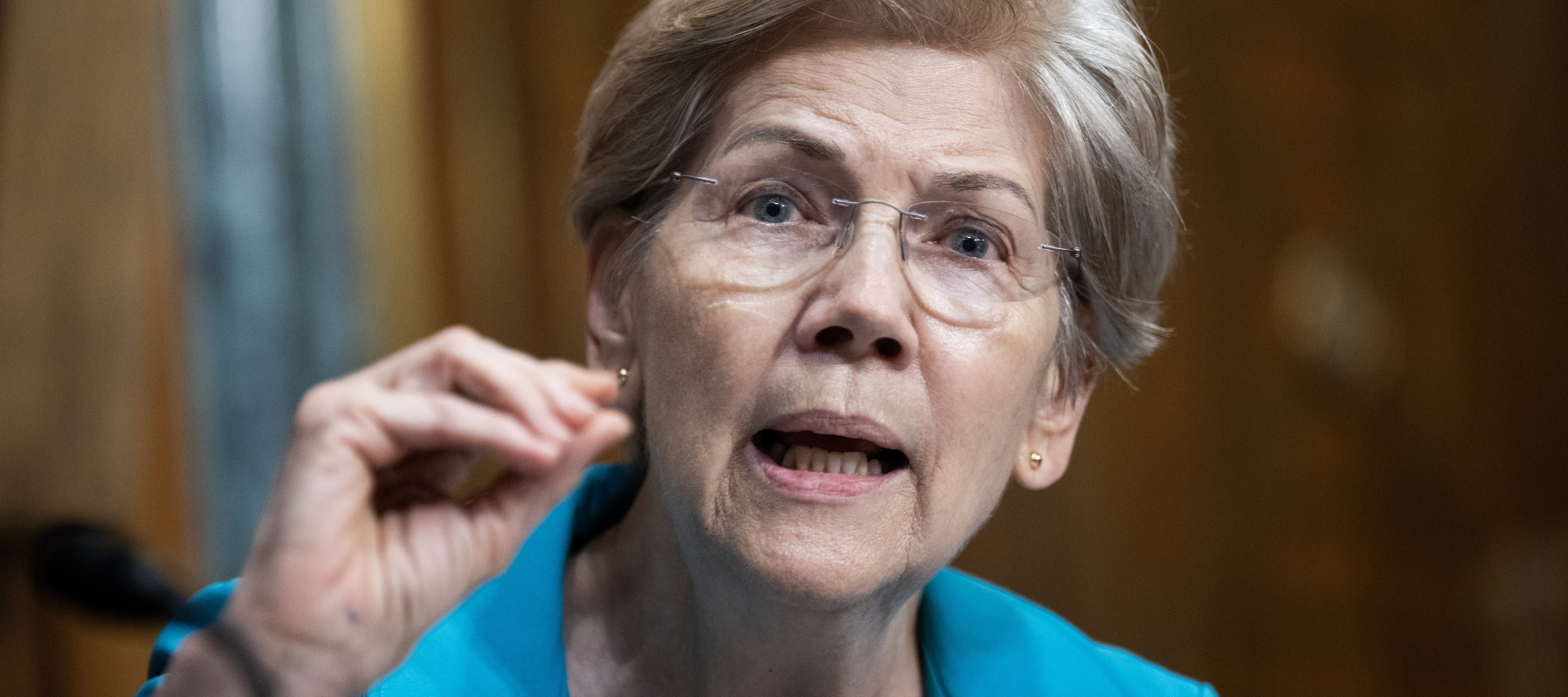 Sen. Elizabeth Warren, D-Mass., questions a representative during a Senate Finance Committee hearing.