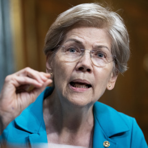 Sen. Elizabeth Warren, D-Mass., questions a representative during a Senate Finance Committee hearing.