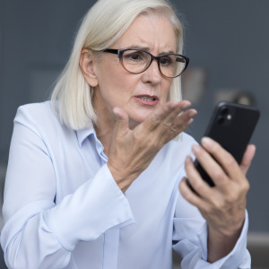 Woman annoyed after receiving spam call.