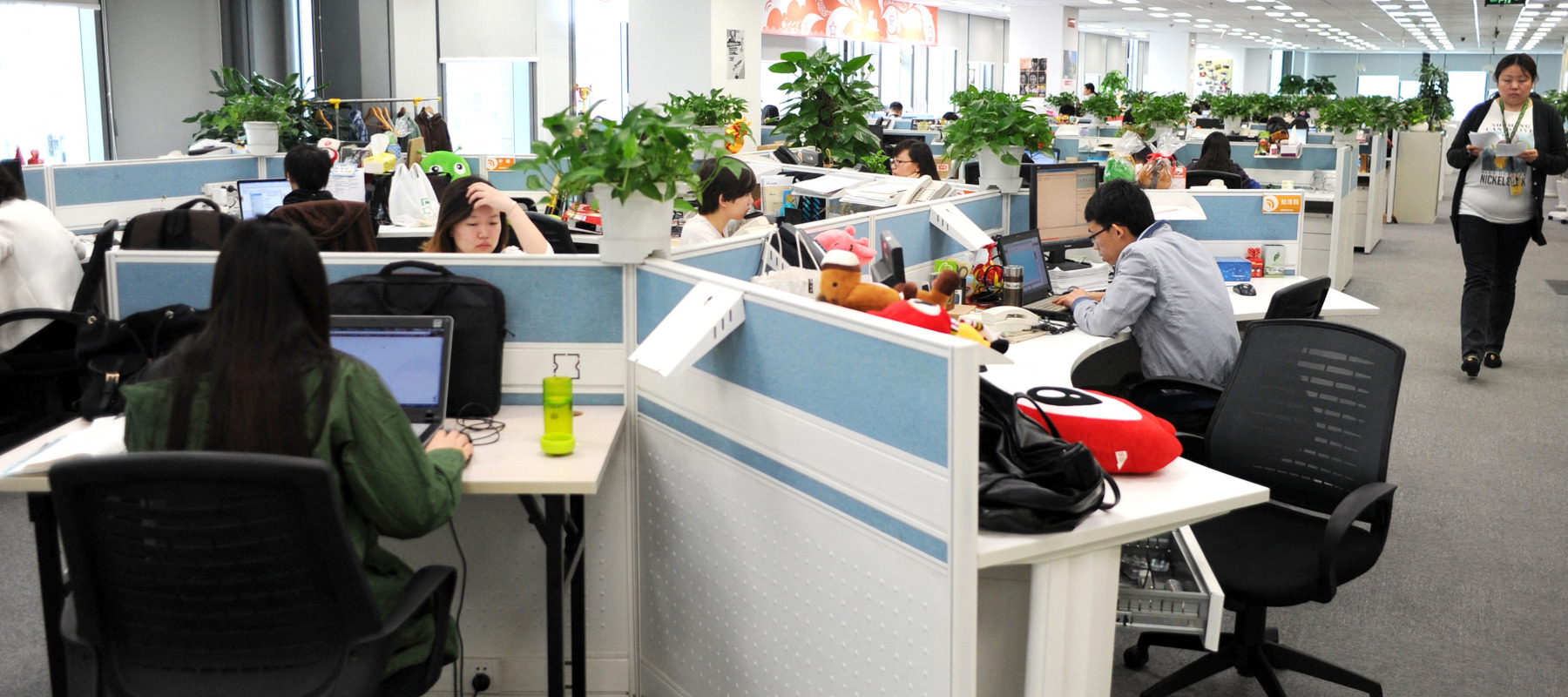 Employees work in an office in China