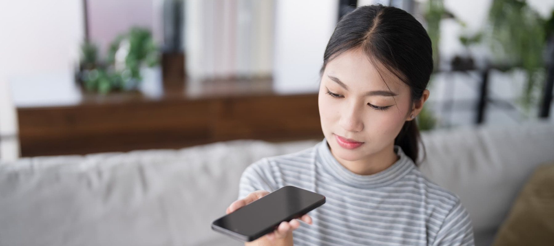 A photo of a woman using a smartphone