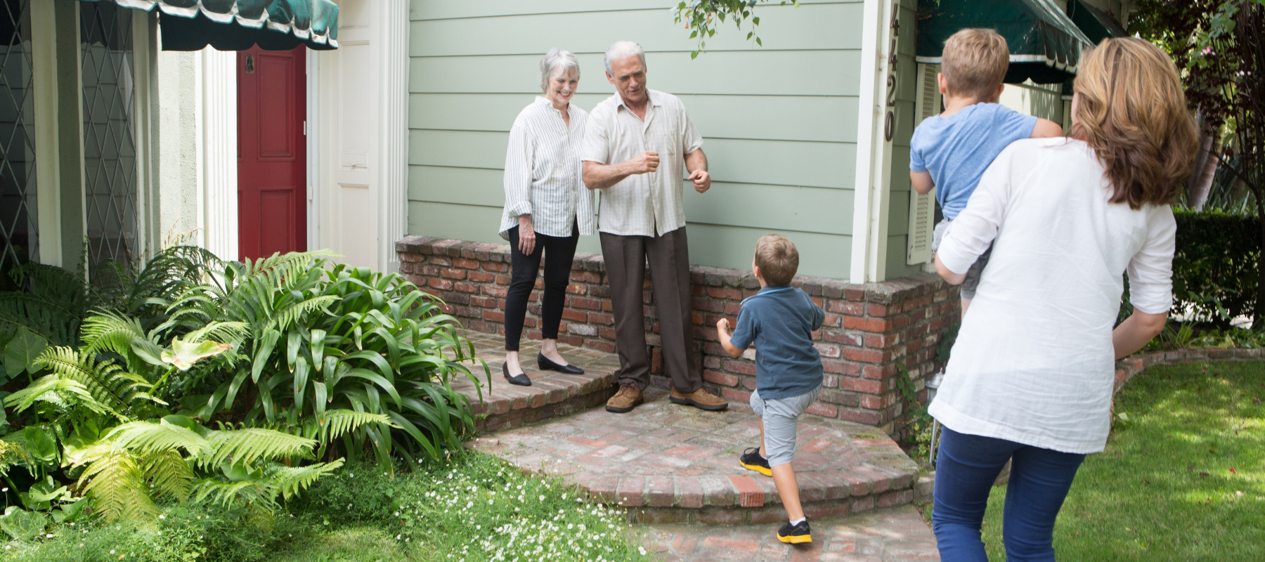 An elderly couple welcomes the next generation to their home.