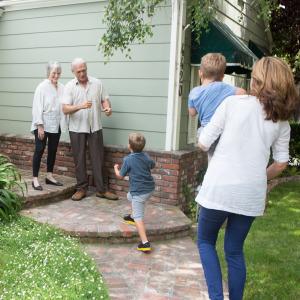 An elderly couple welcomes the next generation to their home.