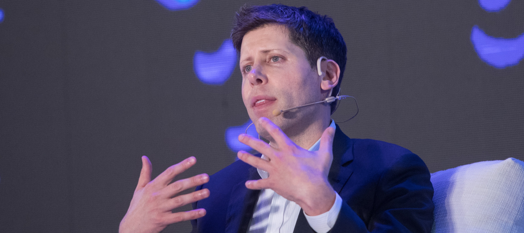 OpenAI CEO Sam Altman speaks onstage at artificial intelligence conference.