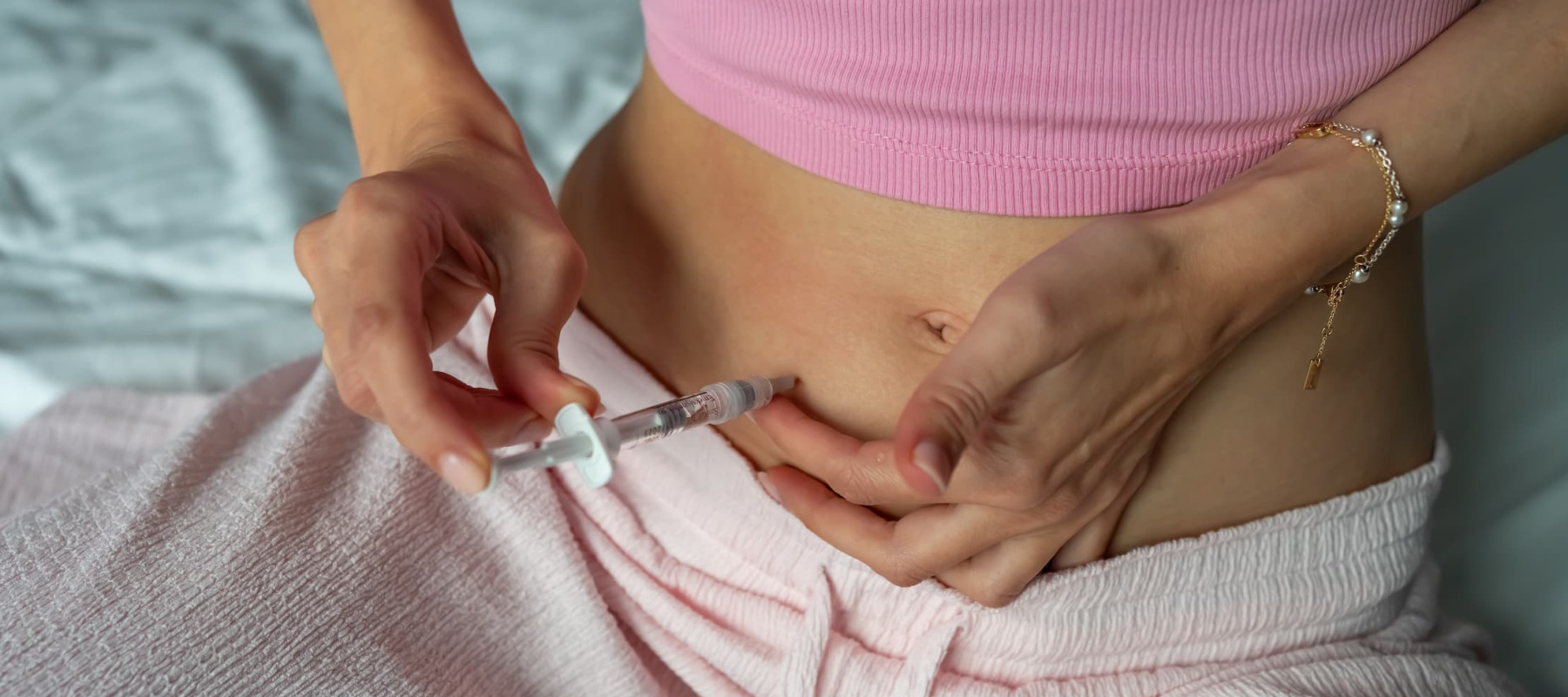 A photo of a woman injecting a peptide