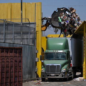 Garbage is transferred to a truck at a waste management center.