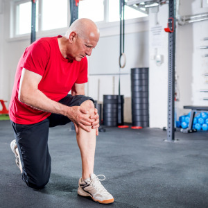 man in gym holding knee