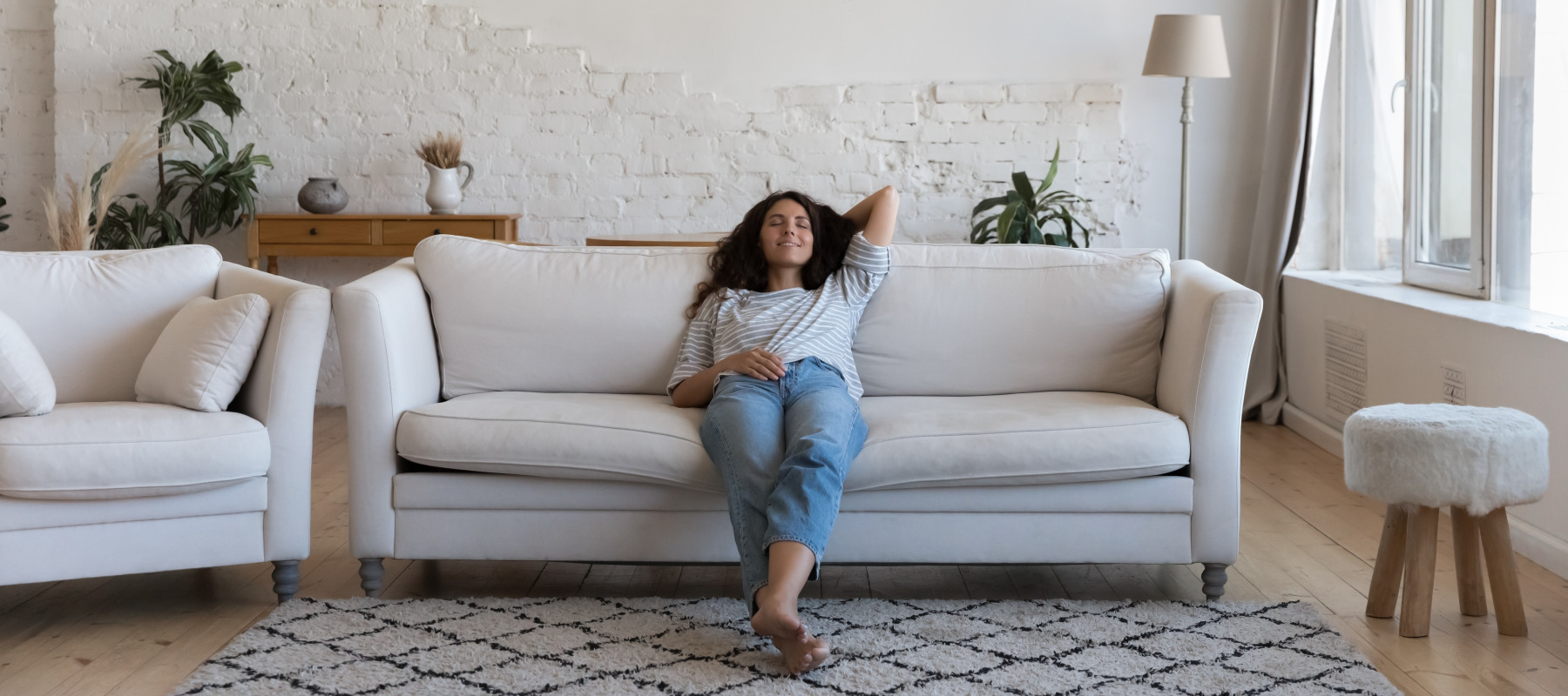 Young woman relaxing in an apartment rental, presumably on vacation.