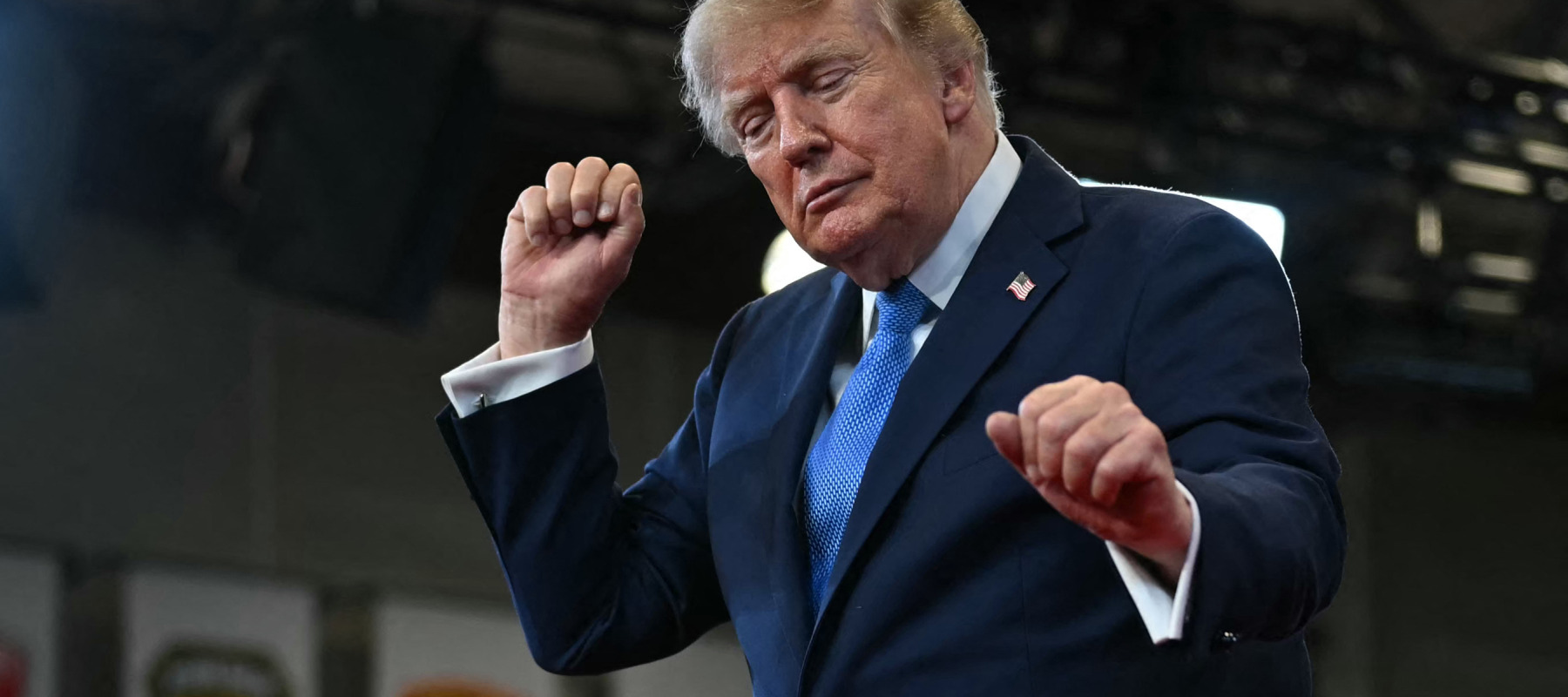 Trump dances as he departs after delivering remarks at the Nassau County Police Academy Center.
