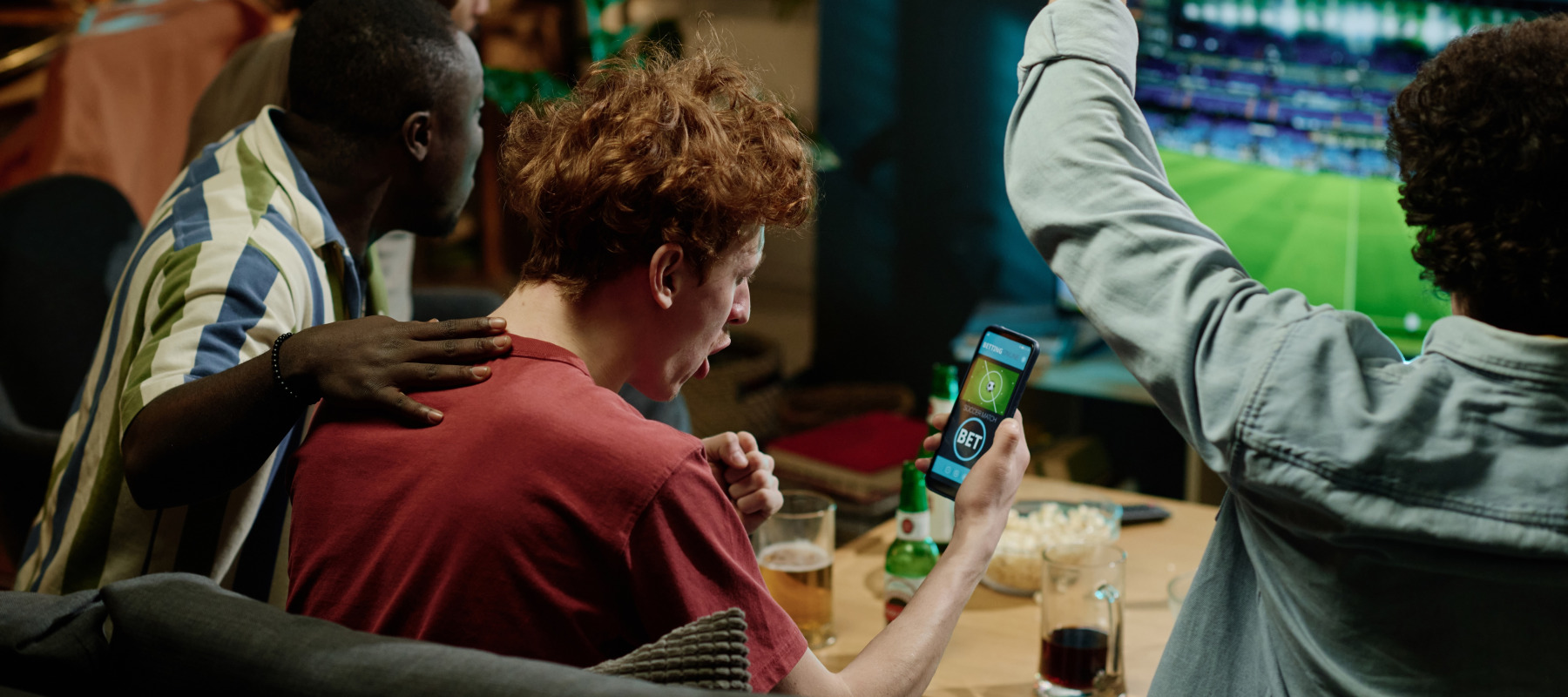 friends watching sports with phone