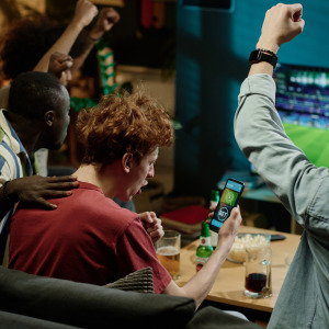 friends watching sports with phone