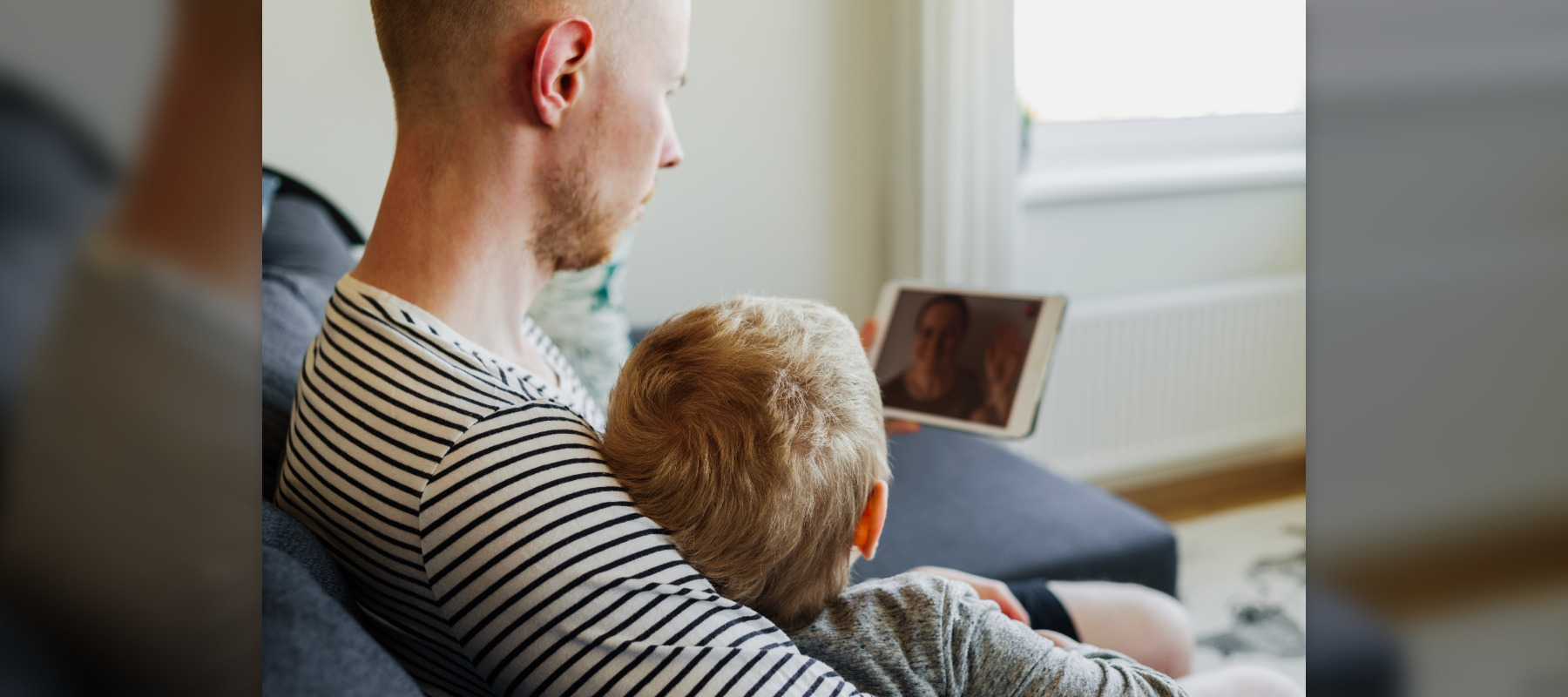 man with kid and ipad