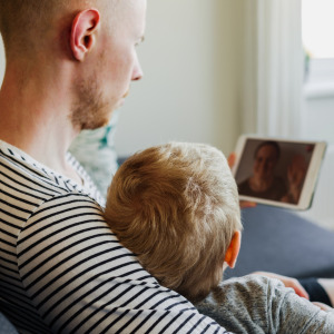 man with kid and ipad