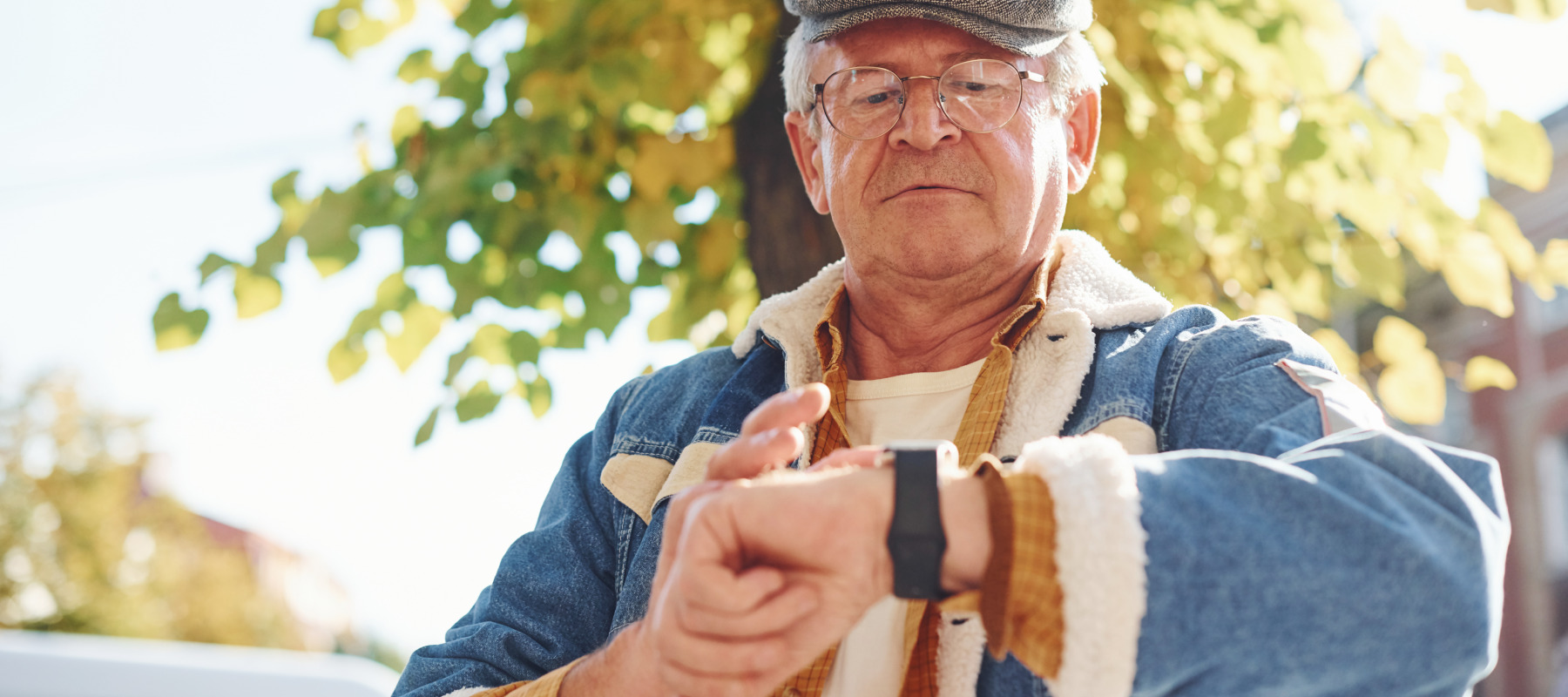 An older man looks at his watch.