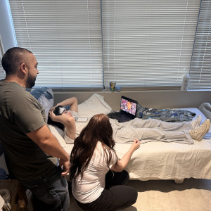 Axeel Melendez recovers in his hospital bed with loved ones at his side.