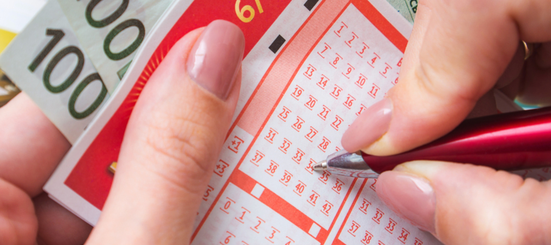 Photo of a woman's hands filling out lottery ticket