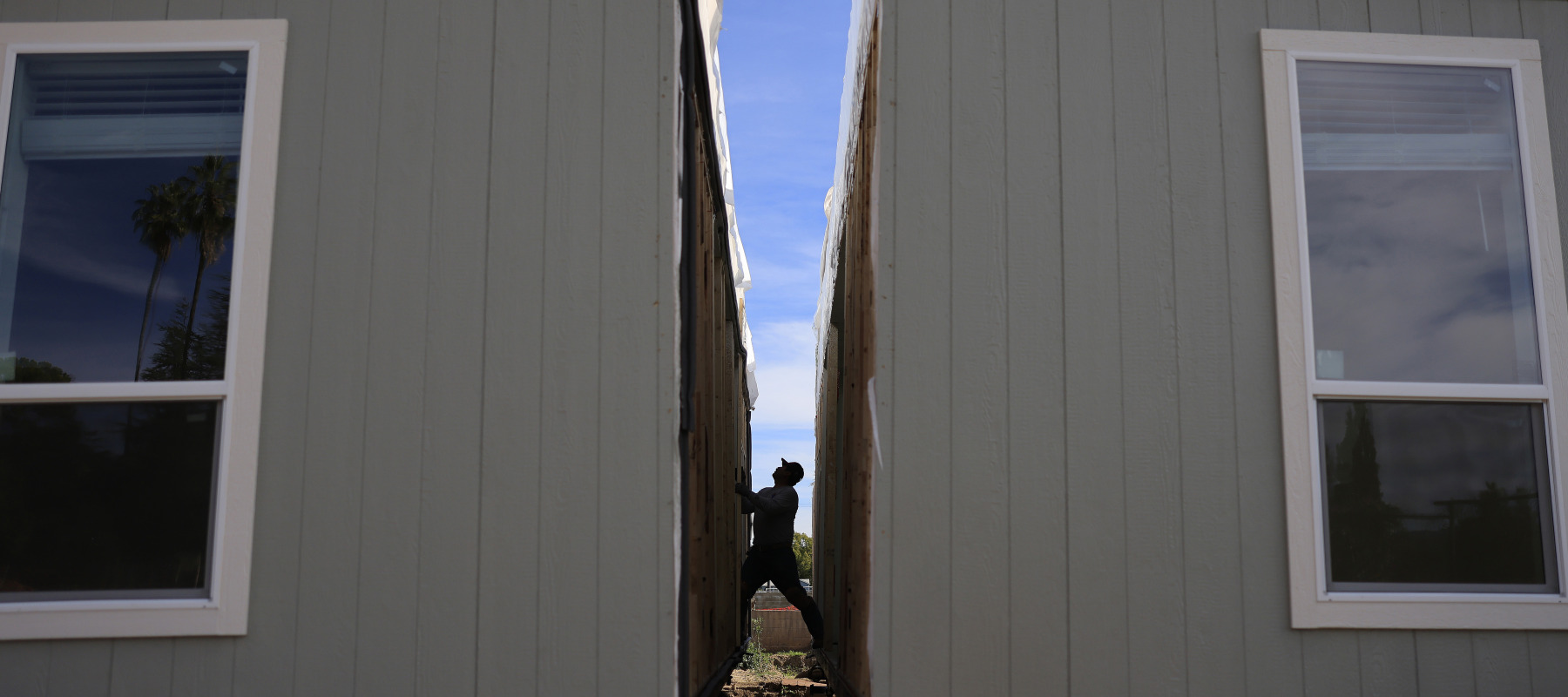 Workers assemble a newly manufactured 1,200-square-foot accessory dwelling unit for members of the Van Dalm family, who are Eaton Fire survivors.