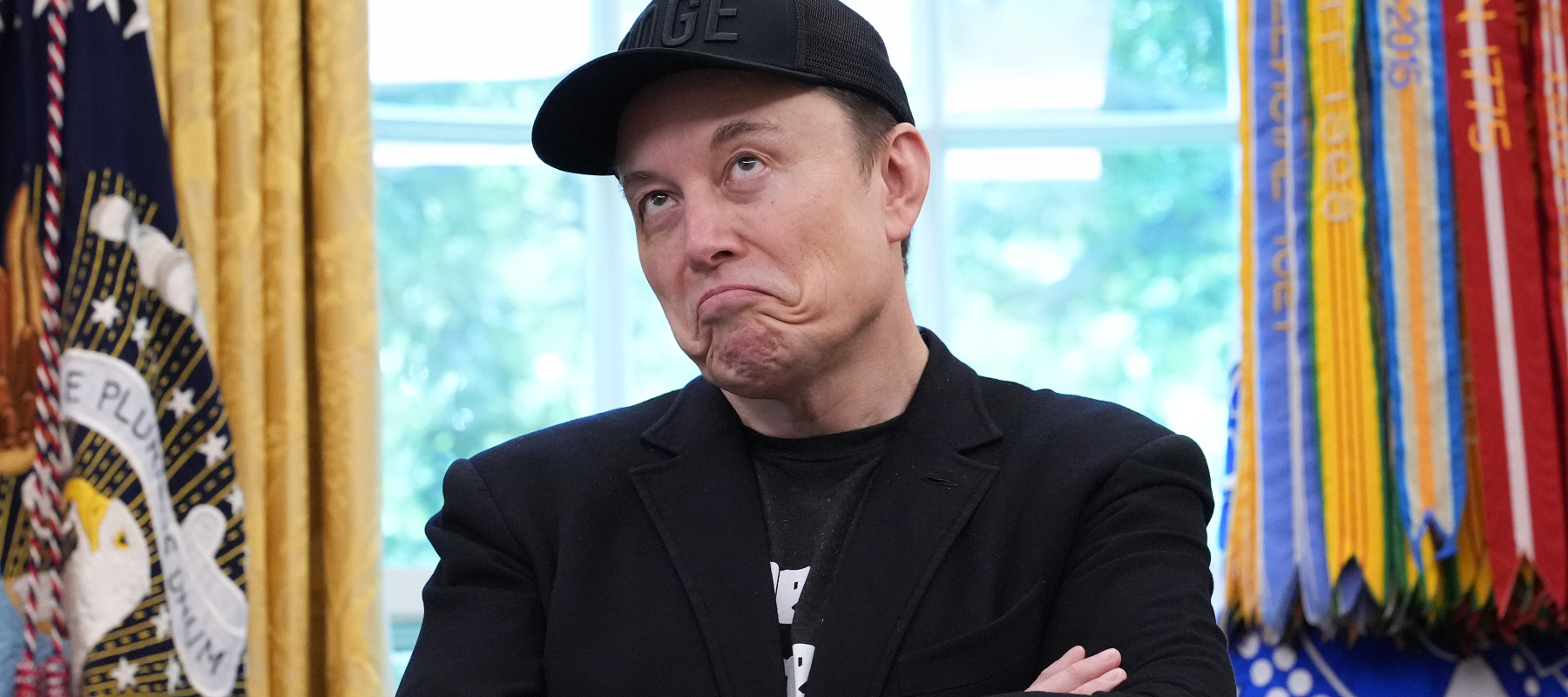 Elon Musk speaks alongside President Trump to reporters in the Oval Office.