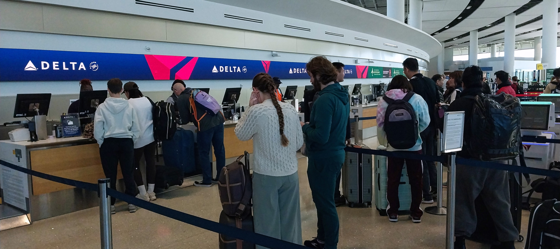 People in line at Delta airport kiosk