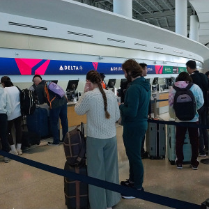 People in line at Delta airport kiosk