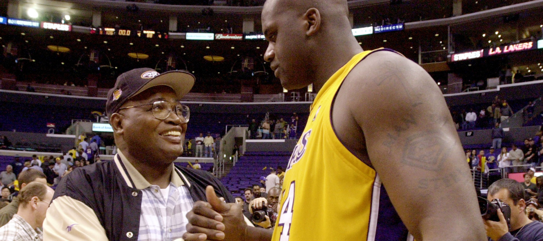 Shaquille O'Neal of the Los Angeles Lakers is congratulated by his father, Philip Harrison.