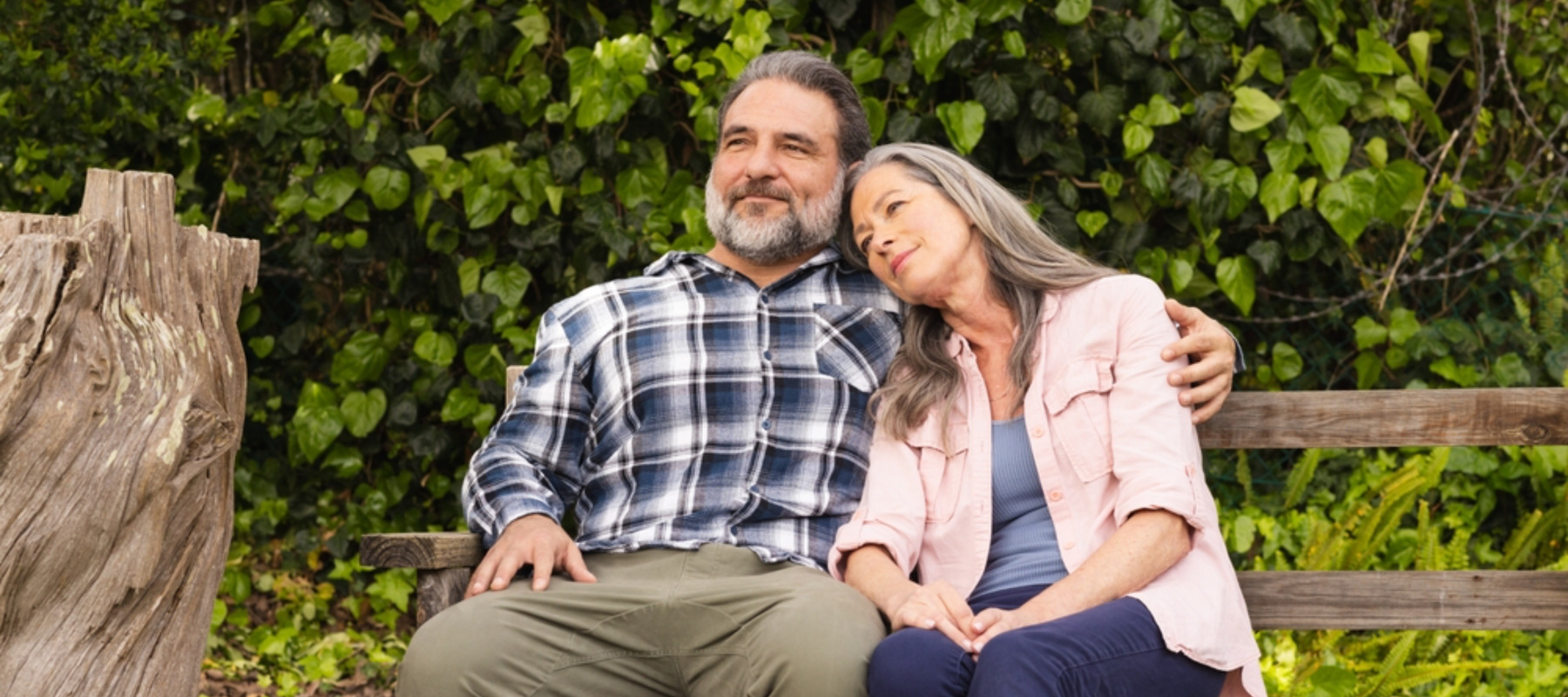 Middle-aged couple on bench outside