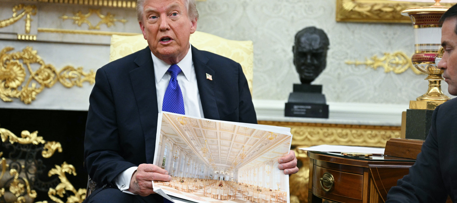 US President Donald Trump shows an image of his planned ballroom as he meets with NATO Secretary General Mark Rutte in the Oval Office of the White House