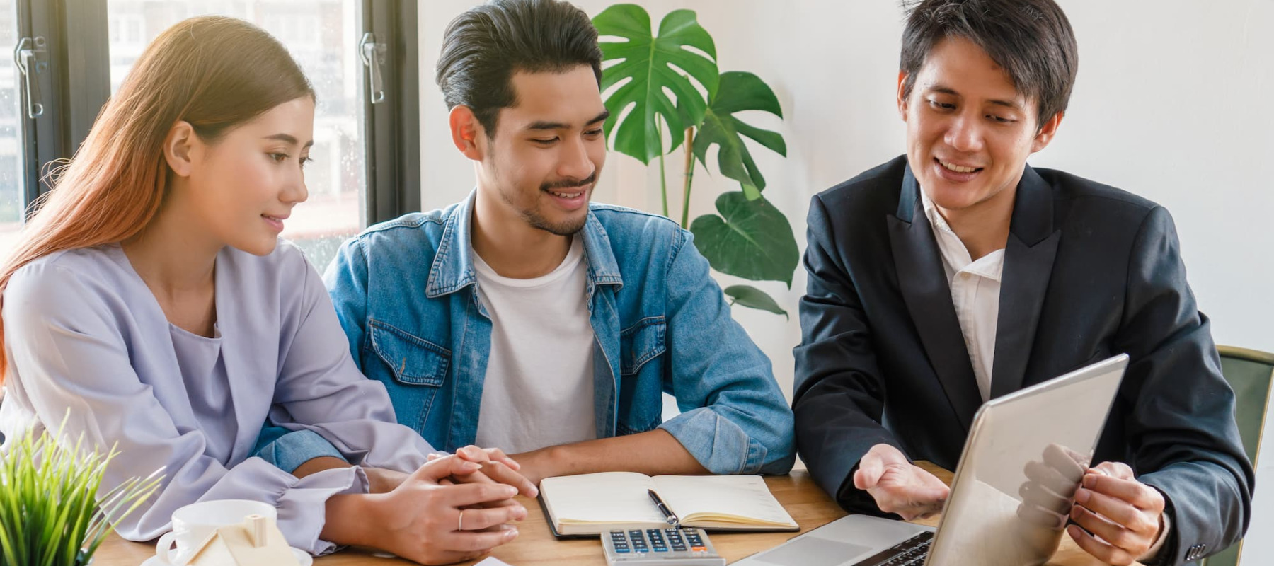 A photo of a couple talking to a realtor