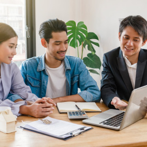 A photo of a couple talking to a realtor