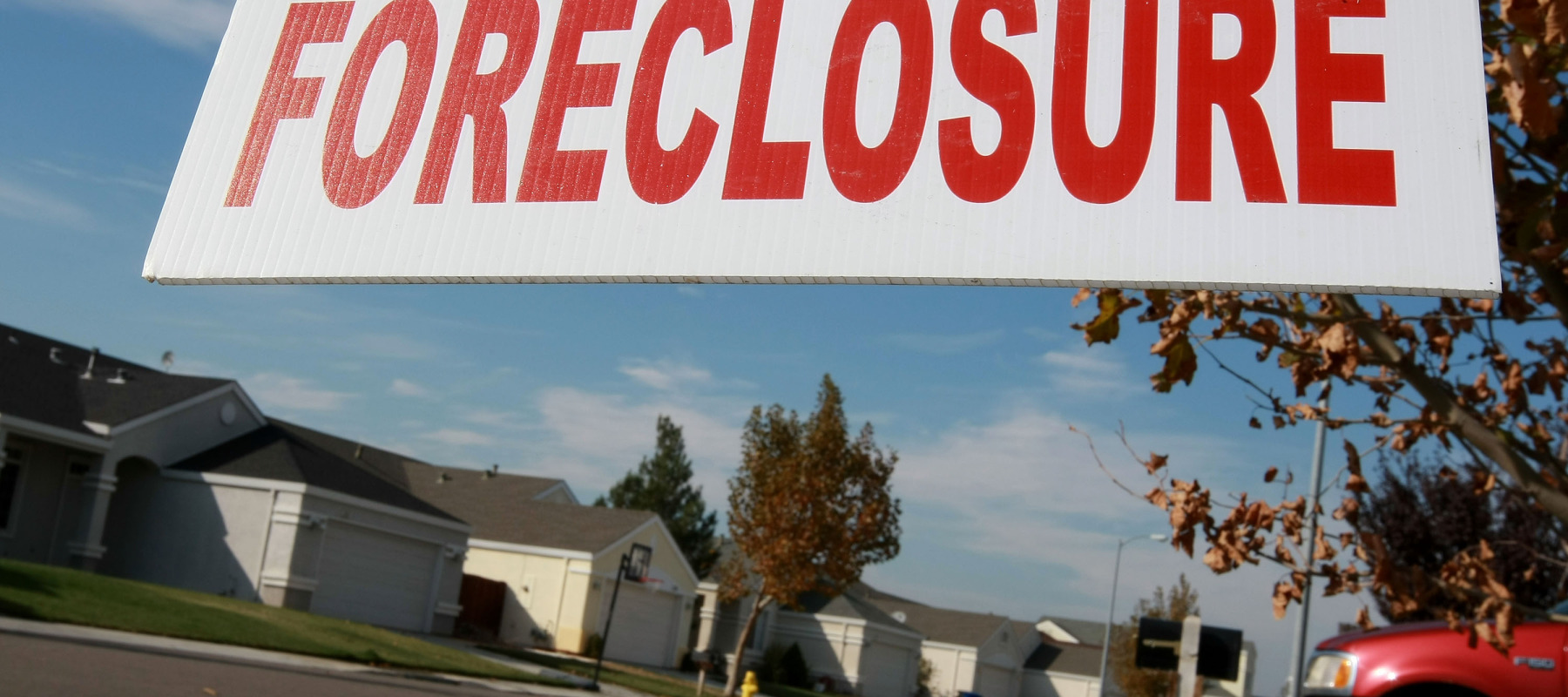 A sign is seen in front of a foreclosed home.